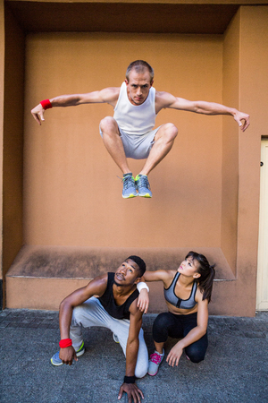 Group of people doing parkour in the city on a sunny day