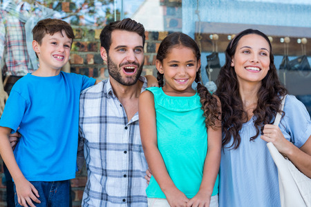 Happy family having fun in the mall on a bright dayの写真素材