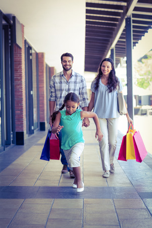 Happy family with shopping bags at the mallの写真素材