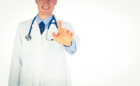 Smiling doctor writing with fingers on white backgroundの写真素材