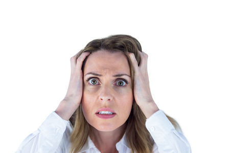 Stressed businesswoman with hands on her head on white backgroundの写真素材
