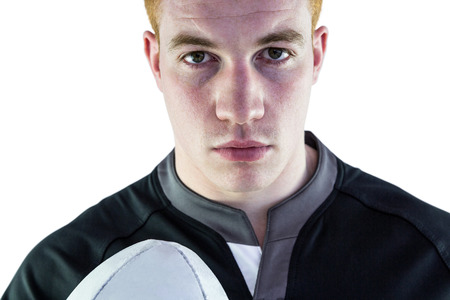 Close up view of a rugby player holding a rugby ballの写真素材