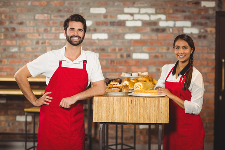 Portrait of two waiters on the counter at the coffee shopの写真素材