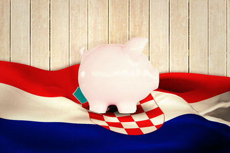 Piggy bank against wooden planksの写真素材