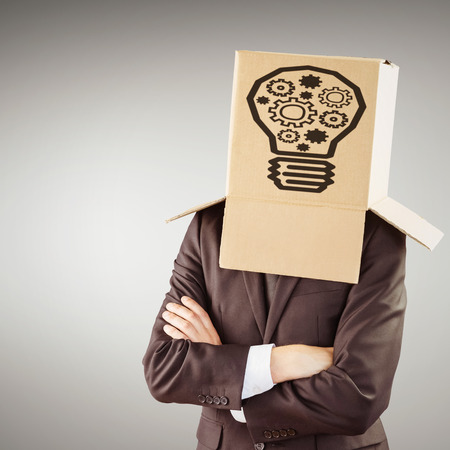 Anonymous businessman with arms crossed against grey vignetteの写真素材