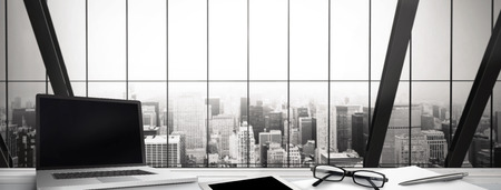 Desk against room with large window looking on cityの写真素材