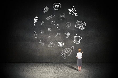 Thinking businesswoman against black wallの写真素材