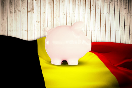 Piggy bank against wooden planks backgroundの写真素材