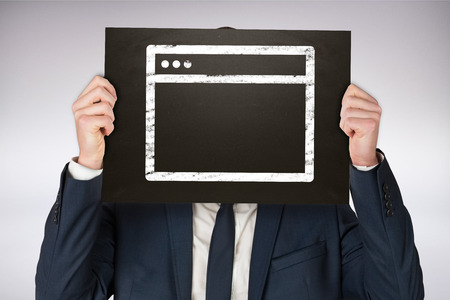 Businessman holding board against grey backgroundの写真素材