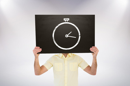 Casual man showing board against grey backgroundの写真素材