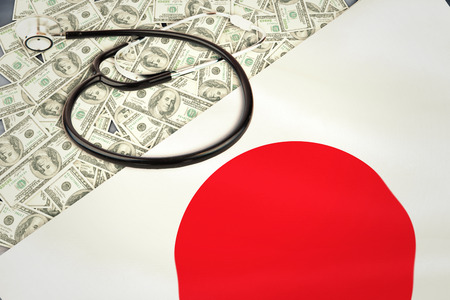 stethoscope against digitally generated japan national flagの写真素材