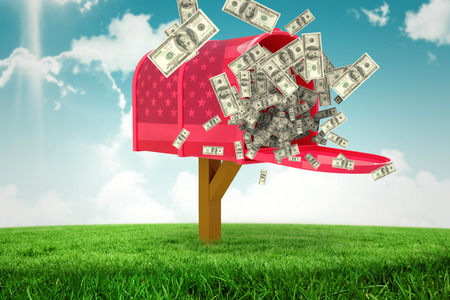 Falling dollars against digitally generated american national flagの写真素材