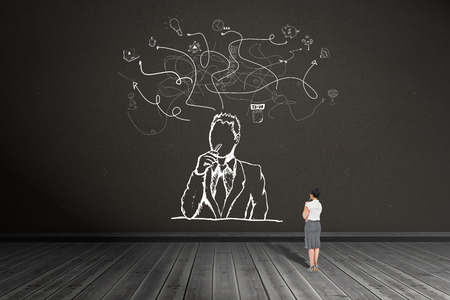 Thoughtful businesswoman against dark roomの写真素材