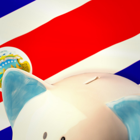Piggy bank against costa rica national flagの写真素材