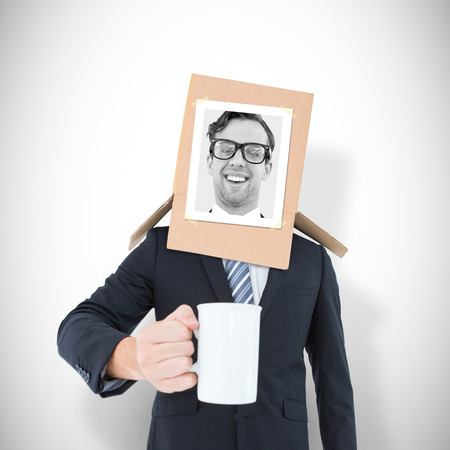 Businessman with photo box on head against white background with vignetteの写真素材