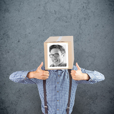 Businessman with photo box on head against dirty old wall backgroundの写真素材