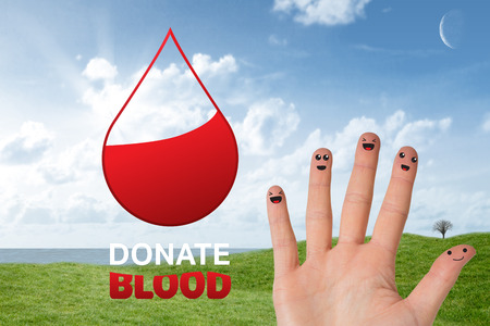 Blood donation against green field under blue skyの写真素材