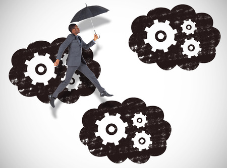 Businessman walking and holding umbrella against white background with vignetteの写真素材