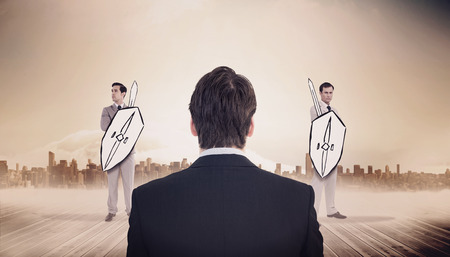 Rear view of businessman standing against large city on the horizonの写真素材
