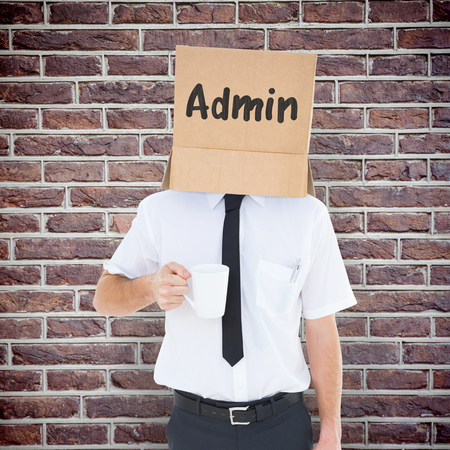 Anonymous businessman against red brick wallの写真素材