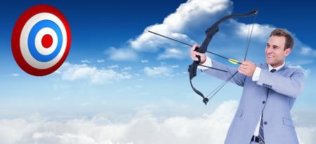 Businessman shooting arrow against bright blue sky with cloudsの写真素材