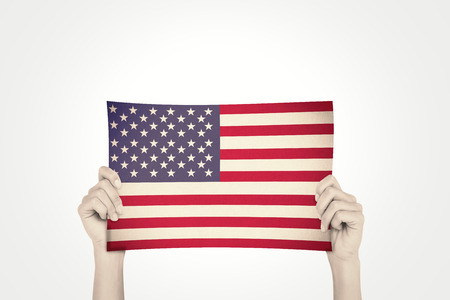 Hand showing card against usa national flagの写真素材