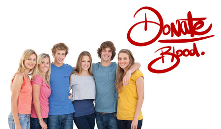 Blood donation against a group of friends smiling and holding each otherの写真素材