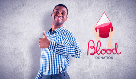 Happy businessman smiling at camera against white and grey backgroundの写真素材