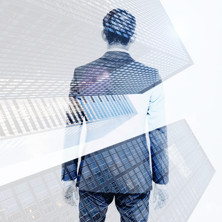 Asian businessman against skyscraperの写真素材