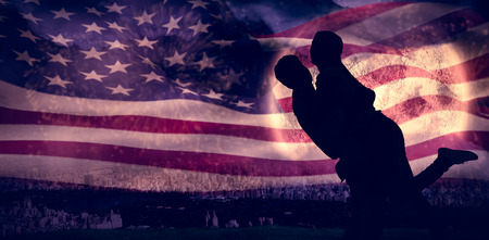 Attractive young couple hugging each other against colourful fireworks exploding on black backgroundの写真素材