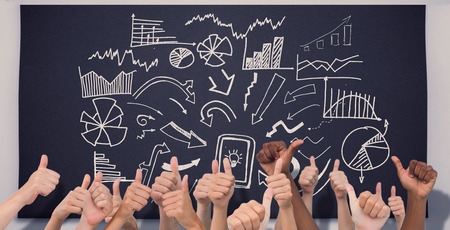 Hands giving thumbs up  against black chalkboardの写真素材