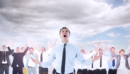 Shouting businessman against cloudy sky backgroundの写真素材