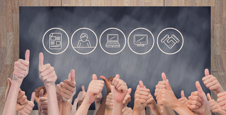 Hands giving thumbs up  against composite image of black cardの写真素材