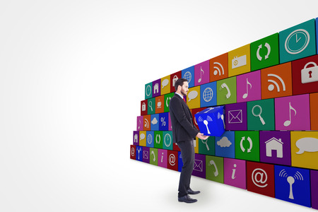 Unsmiling businessman holding something with his hands against wifi appの写真素材