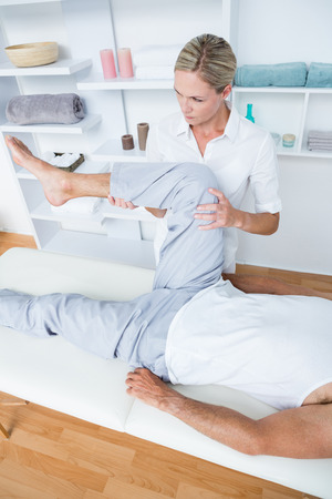 Man having leg massage in medical officeの写真素材