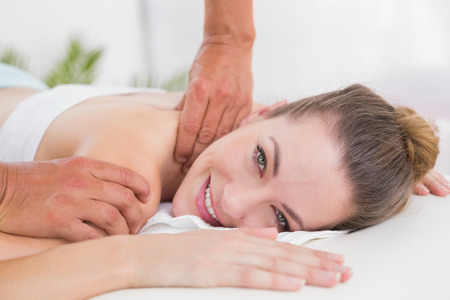 Physiotherapist doing shoulder massage in the medical officeの写真素材