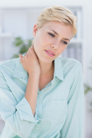Patient with neck pain in medical officeの写真素材