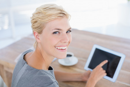 Smiling businesswoman using tablet in her officeの写真素材