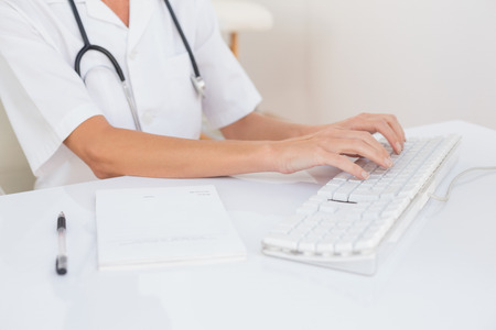 Doctor using computer in medical officeの写真素材