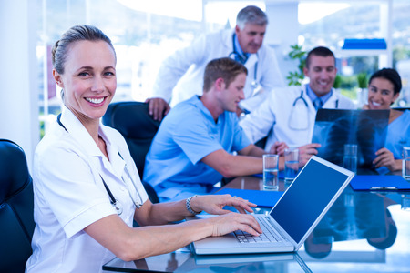 Nurse smiling at the camera during a meeting