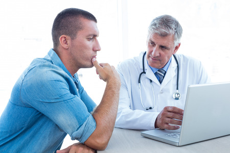 Worried patient with his doctor in medical office