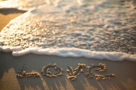 love written on the beach at the sunsetの写真素材
