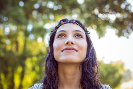 Pretty hipster smiling in the park on a sunny day