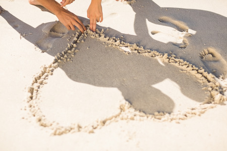 one heart drawn in the sand at the beachの写真素材