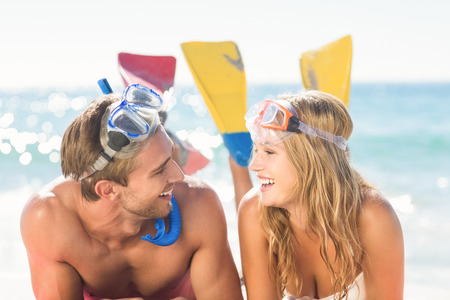 Happy couple with snorkel and flippers at the beachの写真素材