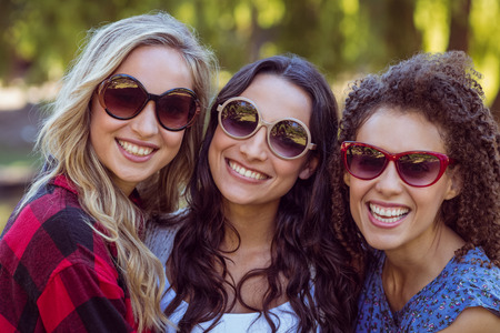 Happy hipsters in the park on a sunny dayの写真素材