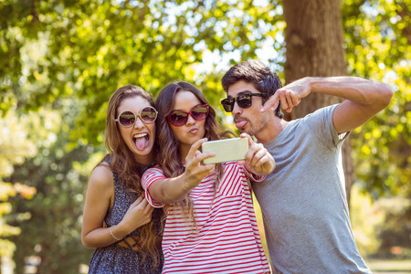 Happy friends taking a selfie on a summers dayの写真素材