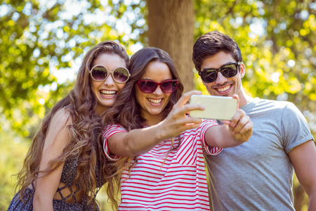 Happy friends taking a selfie on a summers dayの写真素材