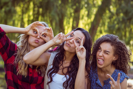 Happy hipsters in the park on a sunny dayの写真素材