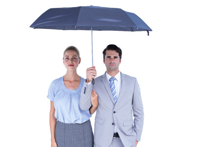 Business people holding a black umbrella on white backgroundの写真素材